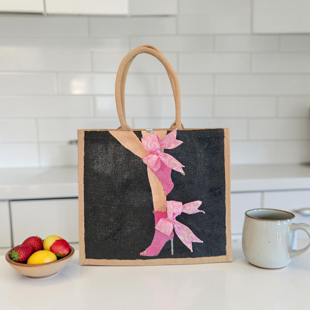 Hand-painted tote bag featuring a pink high heel with bows on a black background with dimensional ribbon accents