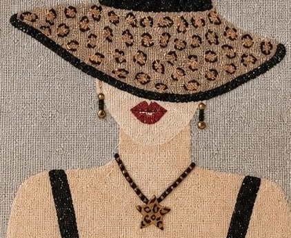 close up of Hand-painted neutral jute tote bag featuring a stylish woman in a leopard-print sun hat with black straps, red lips, statement earrings, and natural woven handles.