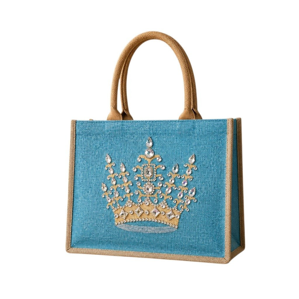 Hand-painted turquoise jute tote bag featuring a jeweled gold crown design embellished with sparkling rhinestones and pearls, finished with natural burlap trim and rounded handles.