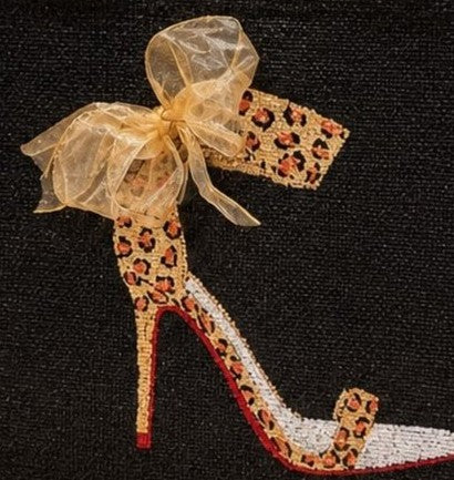 close up of Hand-painted black jute tote bag featuring a leopard print high heel stiletto with a sheer gold bow, red sole accents, and natural jute trim and handles for a bold fashion-inspired look