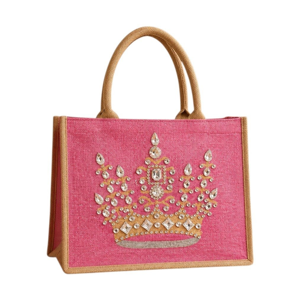 Hand-painted pink jute tote bag featuring an embellished gold crown design with sparkling rhinestones and jewel accents, finished with natural burlap handles and sides.