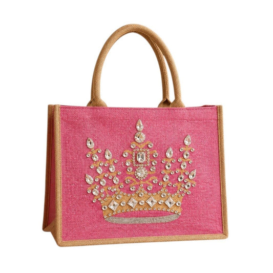 Hand-painted pink jute tote bag featuring an embellished gold crown design with sparkling rhinestones and jewel accents, finished with natural burlap handles and sides.