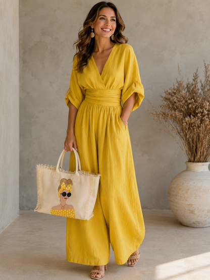 Woman in a yellow outfit carrying the Sunshine Muse hand-painted yellow polka dot fringed tote bag