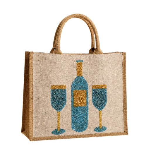 Hand-painted jute tote bag featuring a blue wine bottle and two wine glasses in textured blue and gold detailing on a natural canvas background with braided handles.