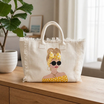Lifestyle image of Sunshine Muse hand-painted fringed canvas tote with blonde woman in yellow polka dots and sunglasses