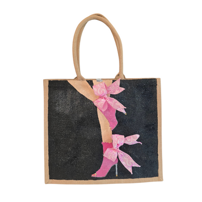 Hand-painted tote bag featuring a pink high heel with bows on a black background with dimensional ribbon accents
