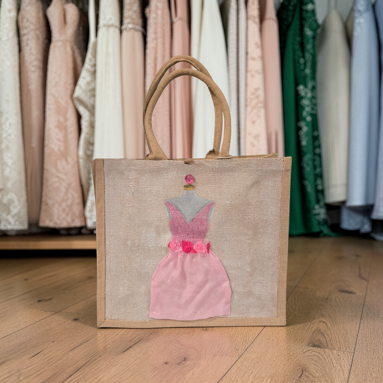 Hand-painted jute tote bag featuring a blush pink bridesmaid dress with floral details on a natural canvas background