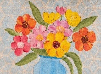 close up of Hand-painted jute tote bag featuring a colorful floral bouquet in a light blue vase against a soft patterned background. The design includes bright pink, yellow, and orange flowers with green leaves, creating a cheerful cottage-inspired look with natural woven handles and artisan charm.