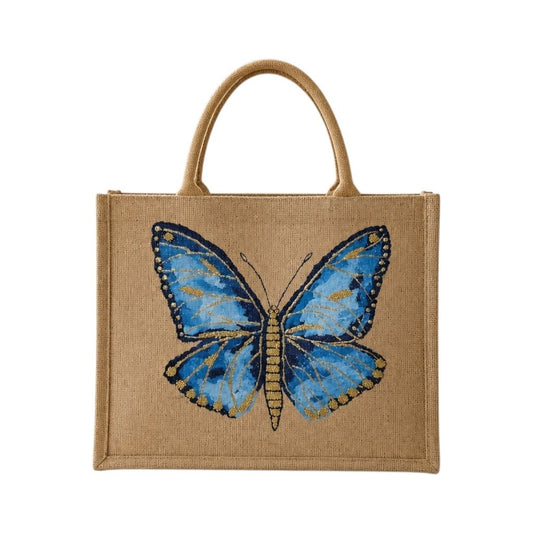 Hand-painted butterfly tote bag on natural jute canvas featuring a vibrant blue butterfly with navy and gold detailing, accented with delicate gold highlights and intricate wing patterns.