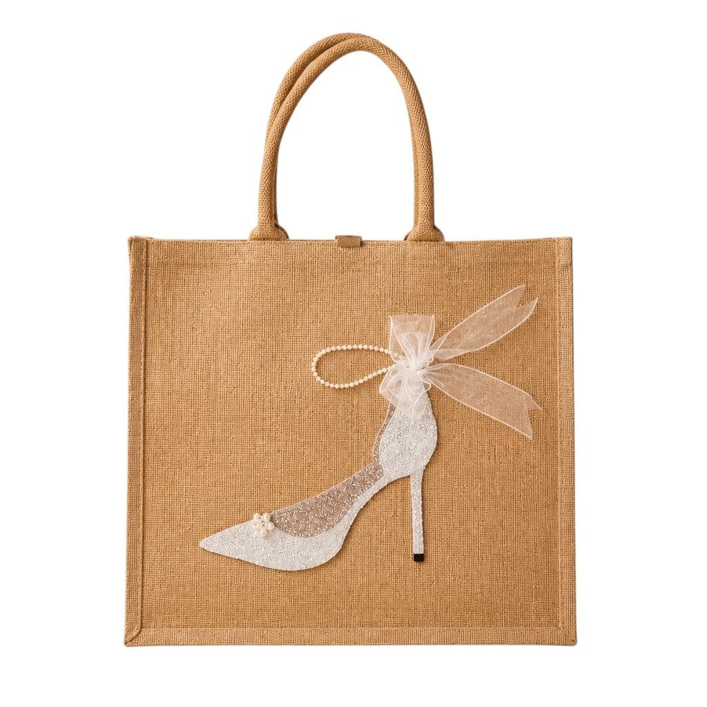 a hand-painted jute tote bag featuring a white glitter stiletto shoe with pearl and ribbon embellishments.