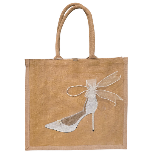 Hand-painted jute tote bag featuring an elegant white bridal stiletto with pearl and ribbon details on a natural canvas background
