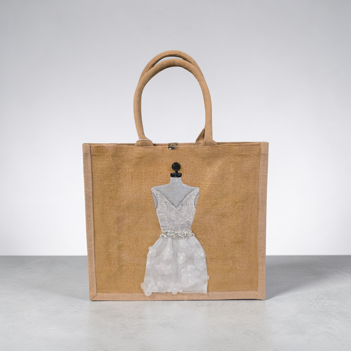 Hand-painted jute tote bag featuring an elegant white bridal dress with shimmering details on a natural canvas background