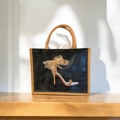 Black jute tote bag with hand-painted copper animal print stilettos and red soles, featuring beaded embellishments.