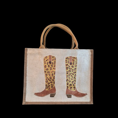 Off white jute tote bag with hand-painted leopard print cowboy boots, detailed with bead accents.