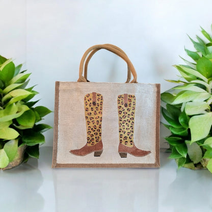 Off white jute tote bag with hand-painted leopard print cowboy boots, detailed with bead accents.