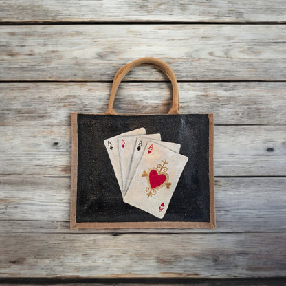 Black jute tote bag with hand-painted four aces playing card design and beaded accents.