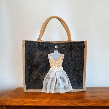 Black jute tote bag with hand-painted white wedding dress design and beaded embellishments.