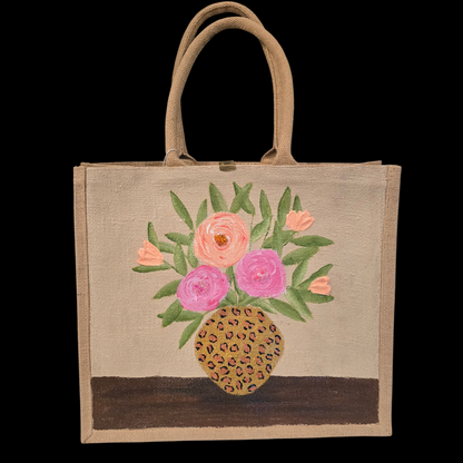 Hand-painted jute tote bag featuring pink and peach flowers arranged in a leopard print vase on a natural canvas background