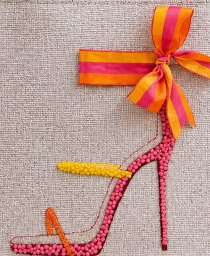 close up of Hand-painted jute tote bag featuring a colorful pink, orange, and yellow embellished stiletto sandal with a striped bow detail and natural woven handles.