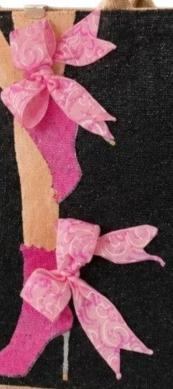 close up of Hand-painted black jute tote bag featuring pink high heel boots with dimensional pink ribbon bows, designed as wearable fashion art with a bold feminine style.