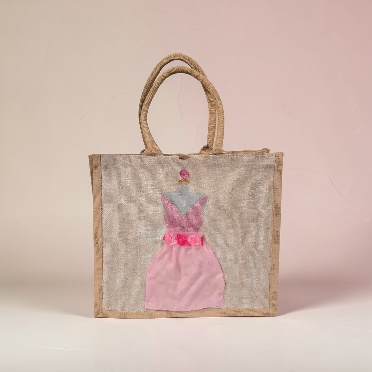 Hand-painted jute tote bag featuring a blush pink bridesmaid dress with floral details on a natural canvas background