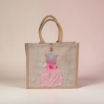 Hand-painted jute tote bag featuring a blush pink bridesmaid dress with floral details on a natural canvas background