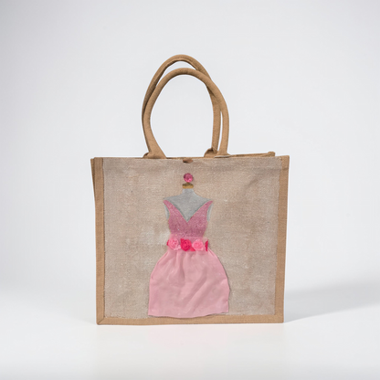 Hand-painted jute tote bag featuring a blush pink bridesmaid dress with floral details on a natural canvas background