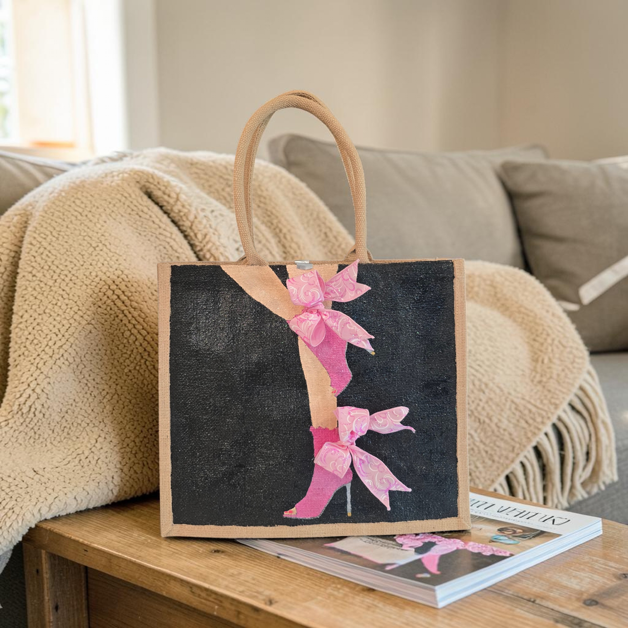 Hand-painted tote bag featuring a pink high heel with bows on a black background with dimensional ribbon accents