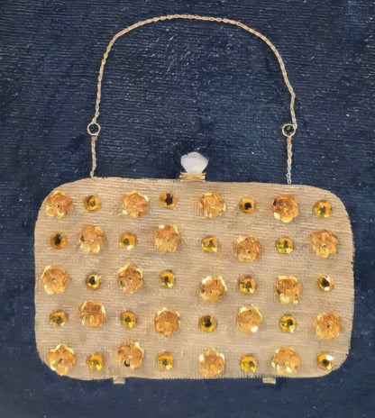 close up of Hand-painted navy blue jute tote bag featuring an embellished vintage-style clutch purse design with sparkling gold jewel accents and dimensional details. Elegant fashion-inspired statement tote with natural jute trim, double handles, and magnetic snap closure. Perfect for dressy occasions, boutique fashion lovers, and unique handmade gift giving.