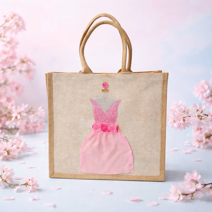 Hand-painted jute tote bag featuring a blush pink bridesmaid dress with floral details on a natural canvas background