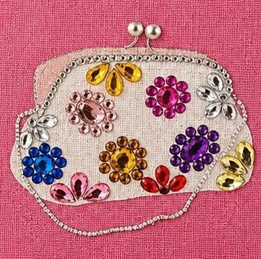 close up of Hand-painted pink jute tote bag featuring a jeweled evening clutch design with colorful gem embellishments, bringing bold glamour and playful elegance to everyday fashion.