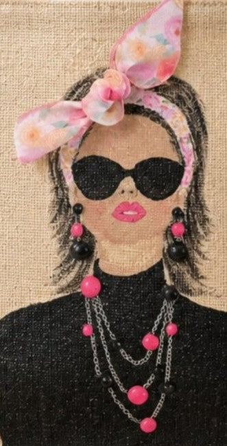 close up of Hand-painted jute tote bag featuring a chic woman wearing oversized black sunglasses, layered pink and black jewelry, and a pink floral headscarf bow against a natural canvas background.