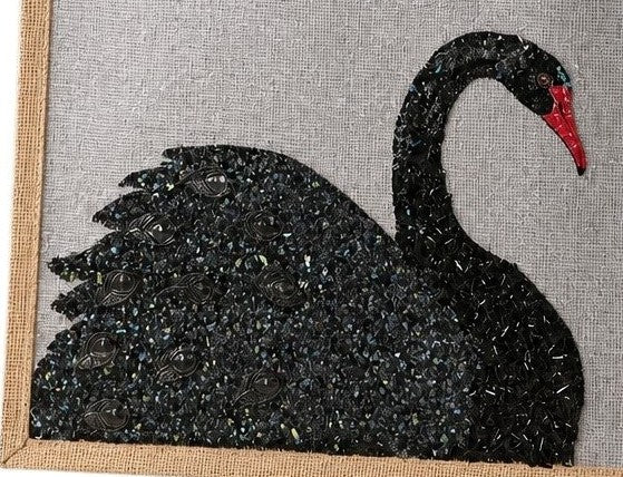 close up of Hand-painted gray jute tote bag featuring an embellished black swan design with textured shimmer details and a red beak. The structured tote has natural woven handles and a sophisticated neutral color palette inspired by elegant, artisan-style fashion accessories.