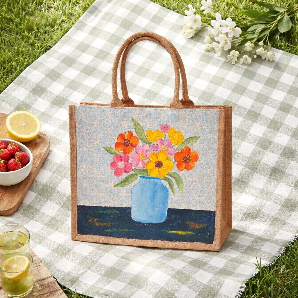 Hand-painted jute tote bag featuring colorful flowers in a blue vase against a light patterned background