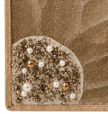 Close up of Hand-painted neutral sunflower tote bag featuring soft beige and taupe petals with pearl and gold jeweled embellishments at the flower center, accented with natural jute trim and rounded padded handles against a neutral background.