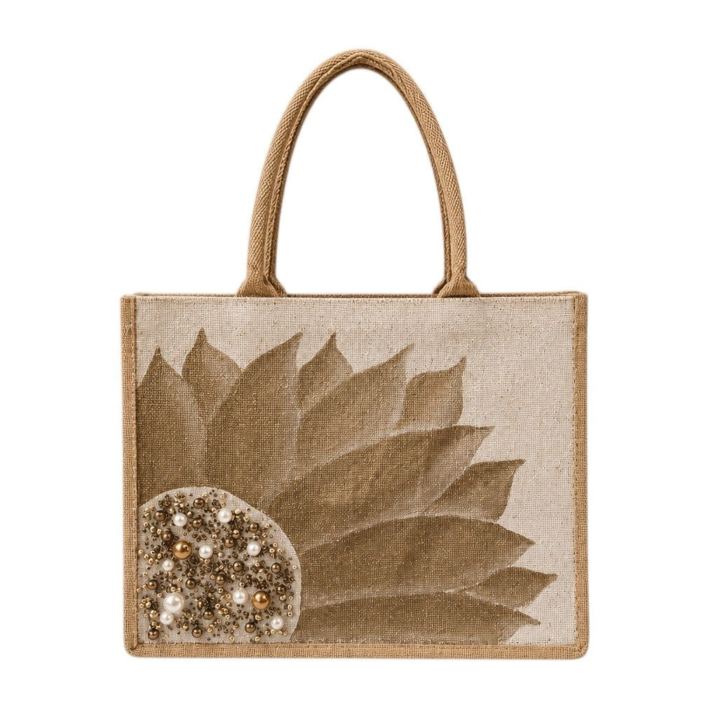 Hand-painted neutral sunflower tote bag featuring soft beige and taupe petals with pearl and gold jeweled embellishments at the flower center, accented with natural jute trim and rounded padded handles against a neutral background.