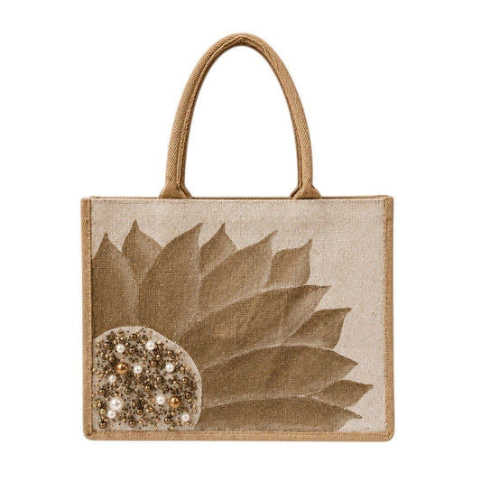 Hand-painted neutral sunflower tote bag featuring soft beige and taupe petals with pearl and gold jeweled embellishments at the flower center, accented with natural jute trim and rounded padded handles against a neutral background.