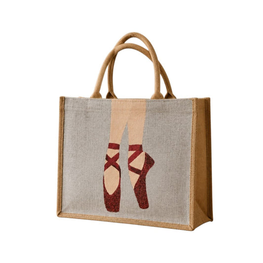 Hand-painted jute tote bag featuring elegant red ballet pointe shoes on a soft neutral background. This dance-inspired tote combines natural woven textures with graceful ballet imagery, creating a stylish and artistic accessory for dancers and ballet lovers.