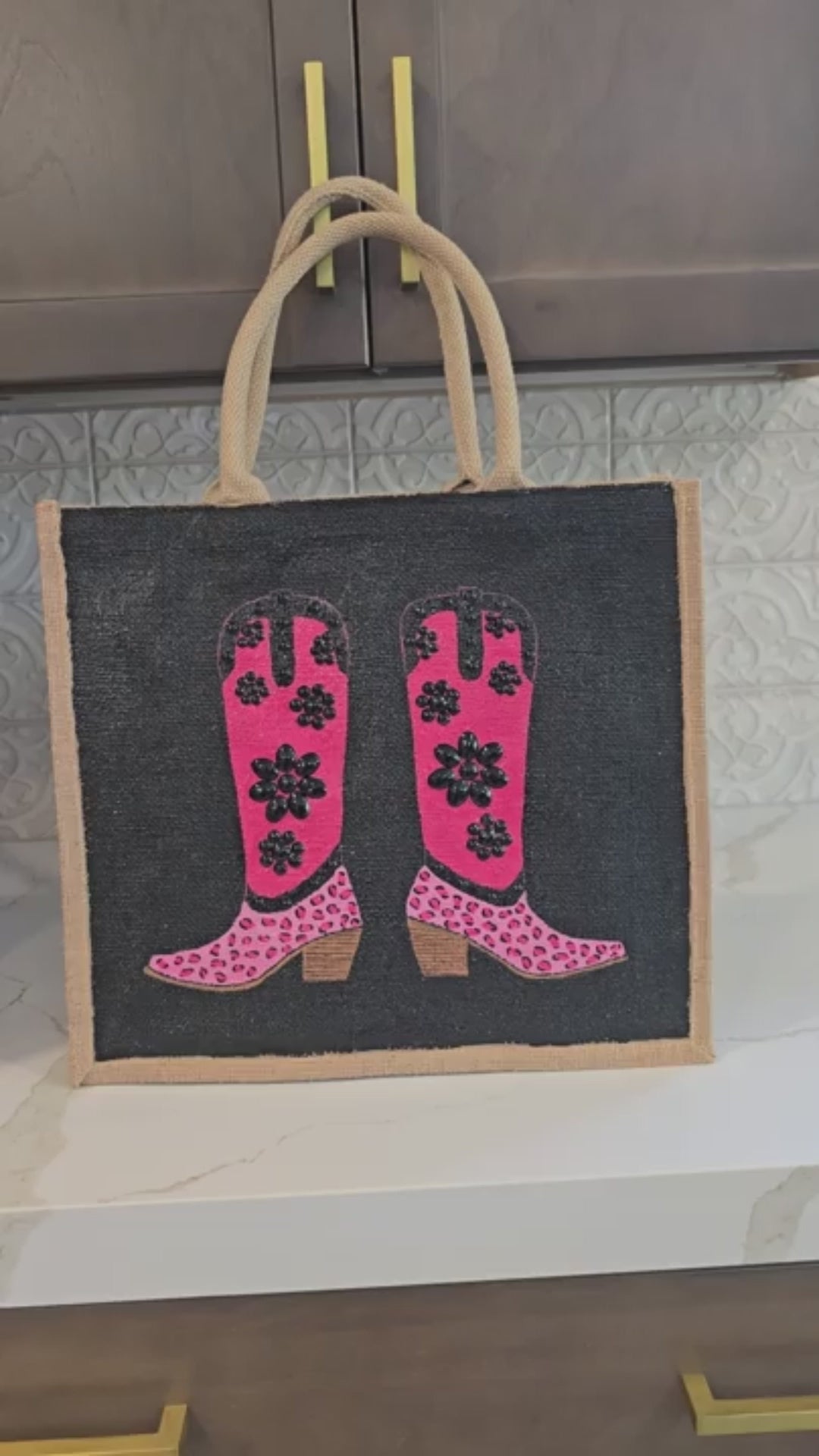 video of Hand-painted pink and black cowboy boot tote bag with black jeweled floral embellishments