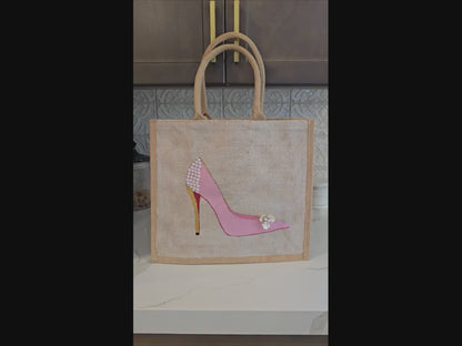 Pink Stiletto hand painted on jute tote bag embellished with jewels and pearls on an off white metallic background.