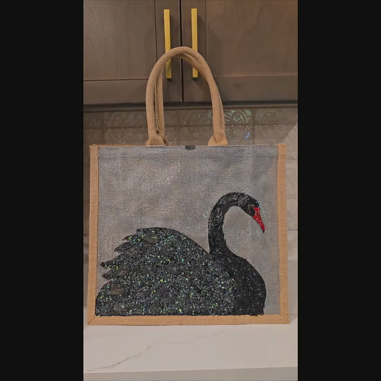 video of Hand painted and embellished black swan tote bag by Dana's Uncommon Glass