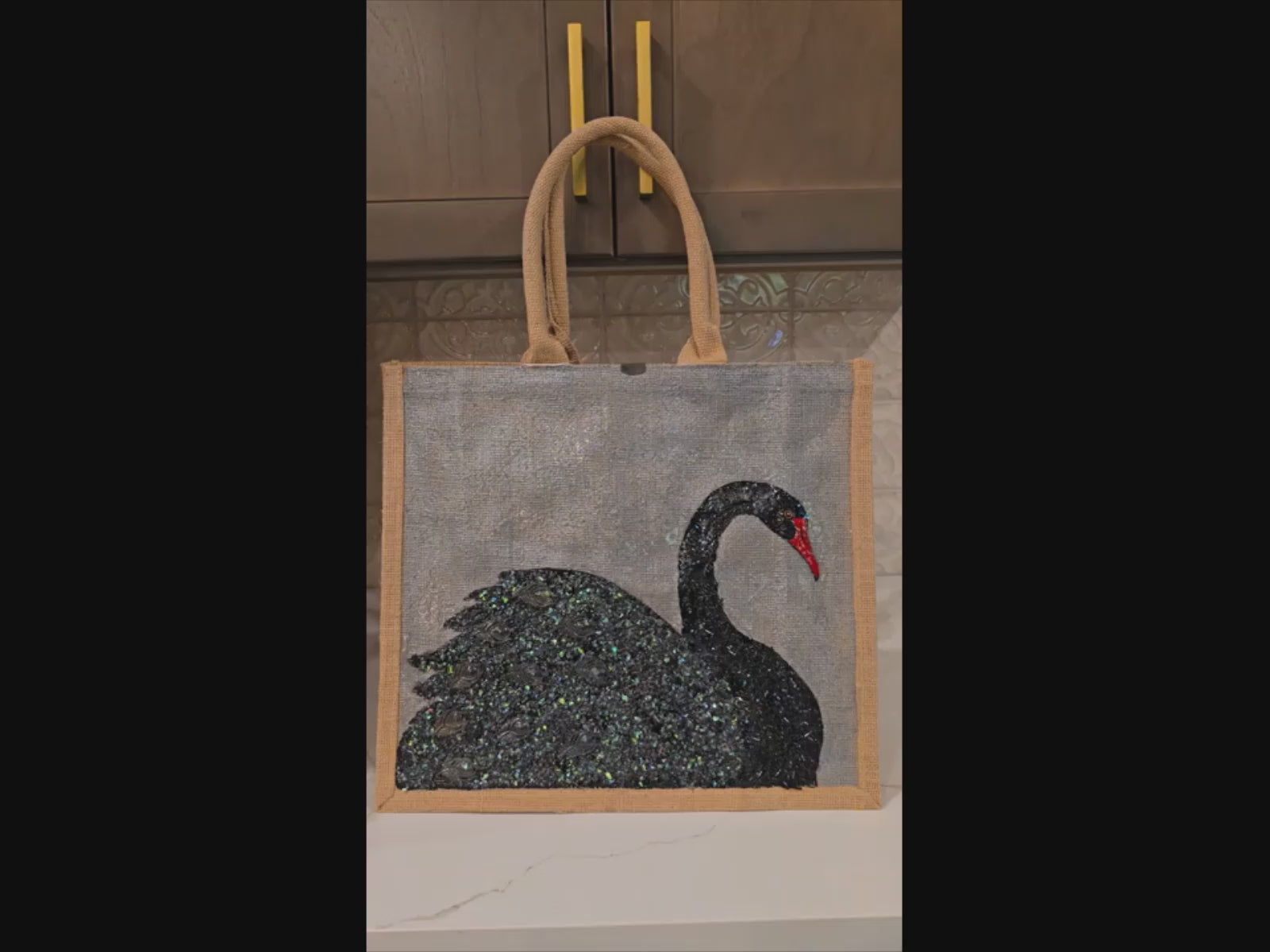 video of Hand painted and embellished black swan tote bag by Dana's Uncommon Glass