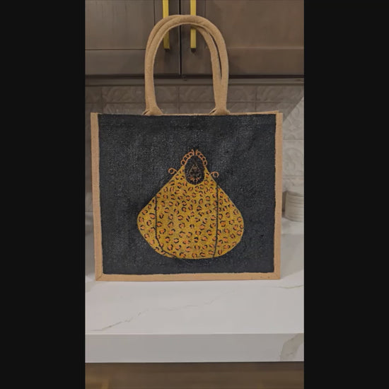 Video of Hand-painted black jute purse tote with gold leopard design and chain handles