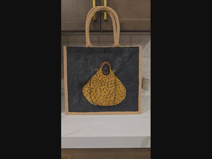 Video of Hand-painted black jute purse tote with gold leopard design and chain handles