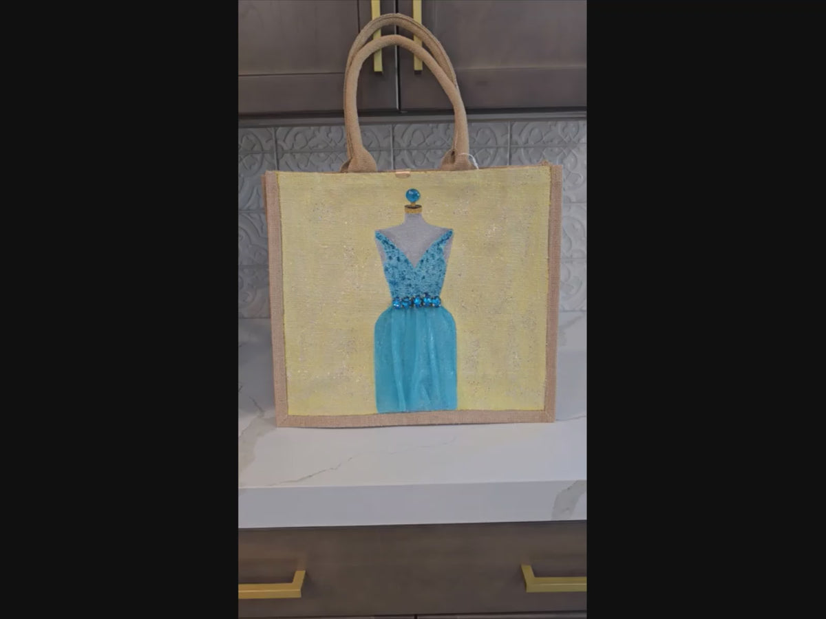 video of Hand-painted bridal tote bag featuring a white embellished wedding dress with textured floral skirt on a natural jute bag, perfect for bride gifts and wedding events.
