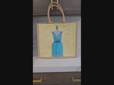 video of Hand-painted bridal tote bag featuring a white embellished wedding dress with textured floral skirt on a natural jute bag, perfect for bride gifts and wedding events.