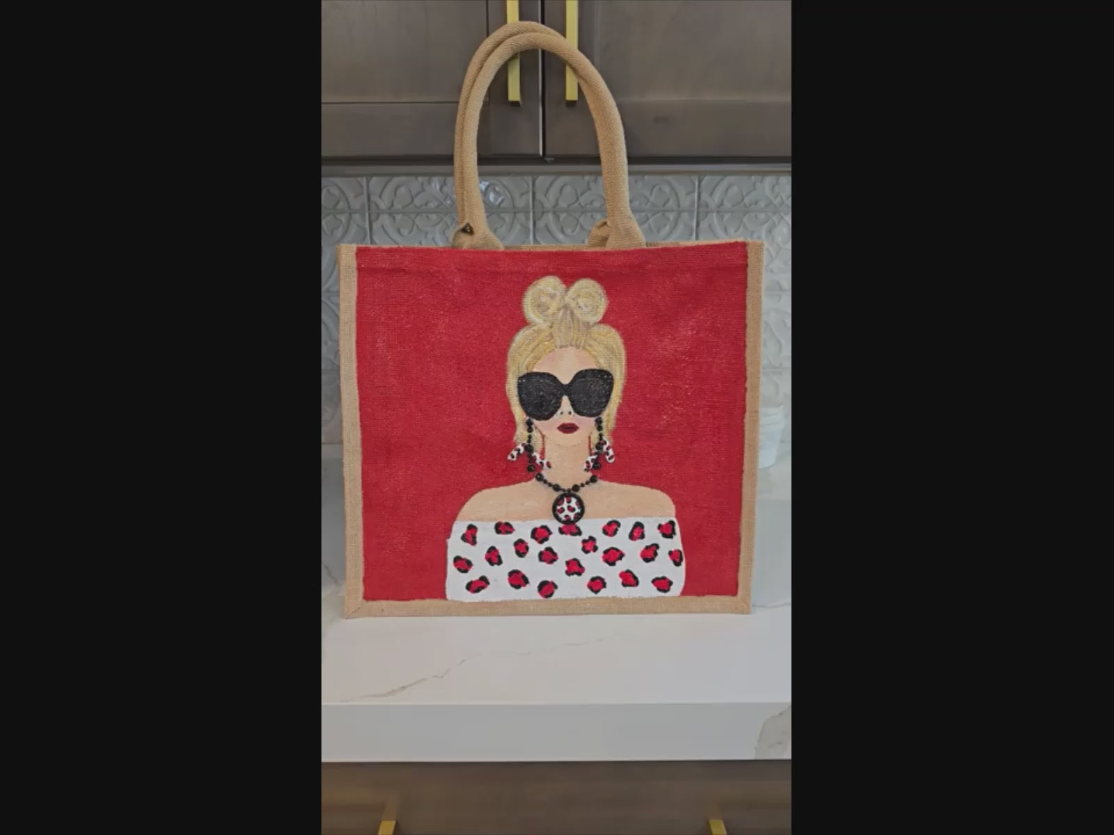 video of Hand-painted crimson red fashion tote bag with stylish woman illustration and leopard-inspired details on jute tote