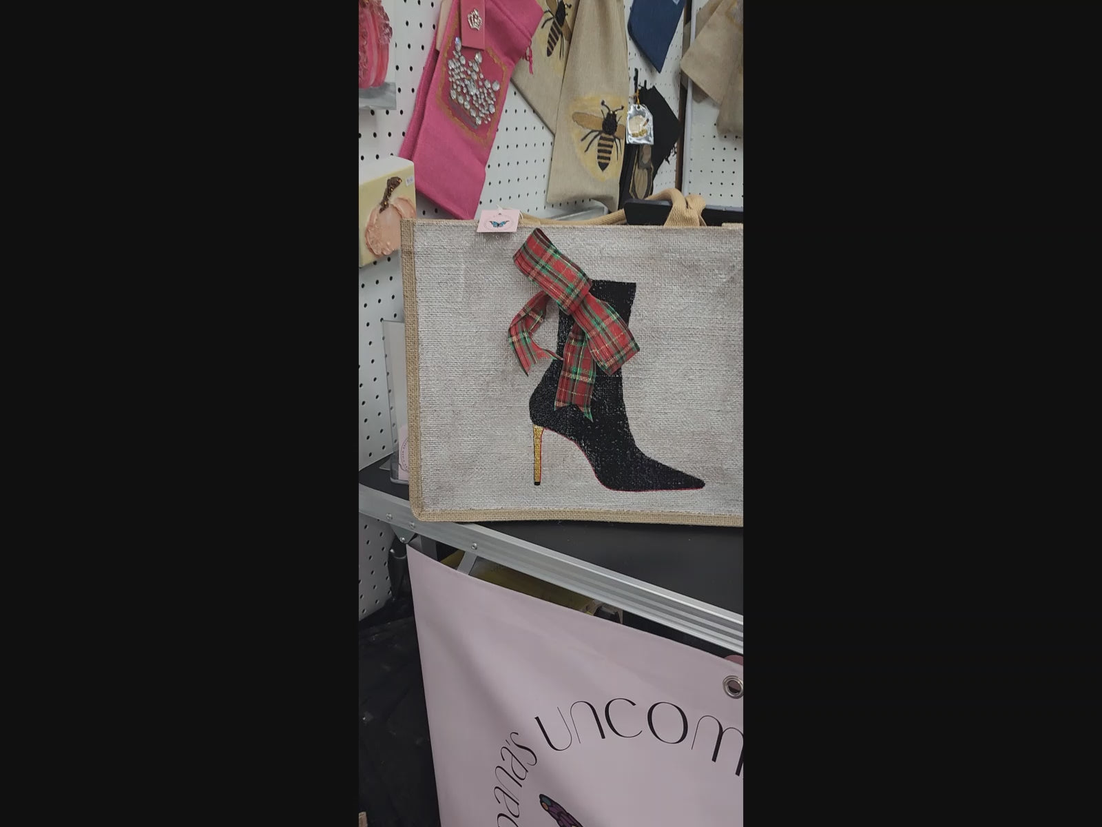 Off white jute tote bag with hand-painted black booties and red soles, featuring beaded embellishments.