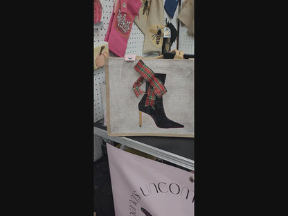 Off white jute tote bag with hand-painted black booties and red soles, featuring beaded embellishments.