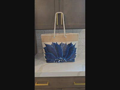 Video of Hand-painted rope handle tote bag with a deep blue sunflower and bead embellishments.
